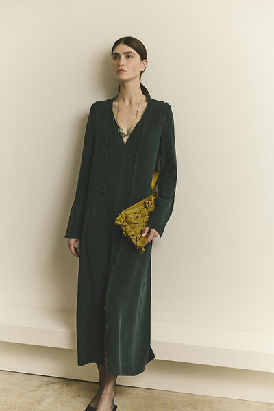 Relaxed model wearing Bottle green sandwashed silk tuxedo dress.