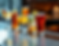show six cocktail and beer drinks on angled bar top with a blurry background .png
