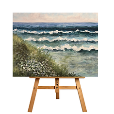 Painting of ocean waves and grassy dunes on an easel, Whispering Sea Breeze.