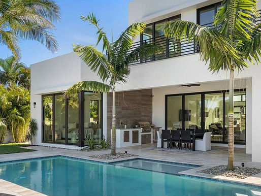 Stylish luxury home with a modern design, surrounded by greenery and featuring a serene pool, reflecting contemporary elegance and premium real estate living.