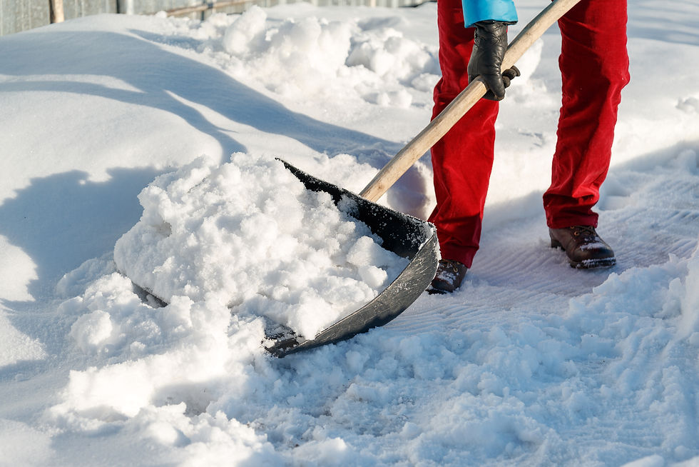 Close-up view of a snow shovel resting on a snowy surface