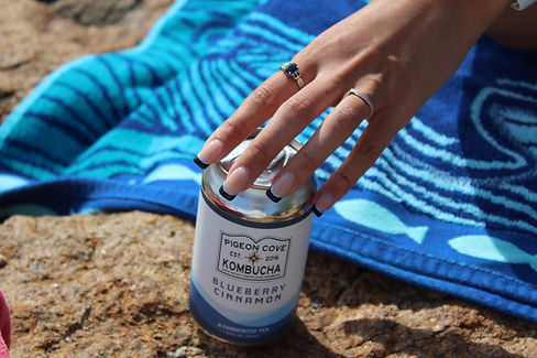 A photo of a hand grabbing a can from the top