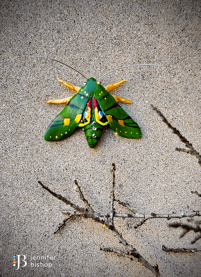 Green and gold Gaudy Sphinx moth sculpture made from polymer clay with crystal accents