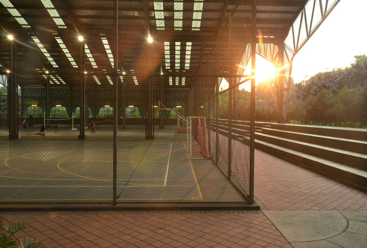 Group of distinct ages warming up together in a parkour gym setting