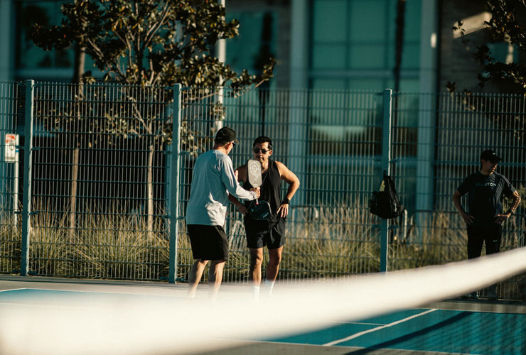 Close up of coach spotting a student doing a flip in a safe gym environment