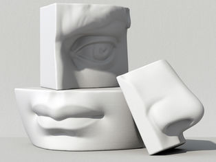 Blocks with human facial features sit atop one another slightly askew