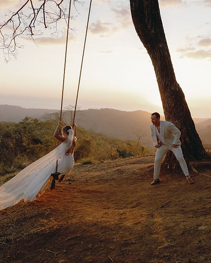 playful couple during a sunset ocean view wedding photoshoot