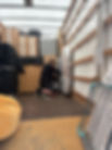 Professional mover meticulously securing bubble-wrapped furniture with heavy-duty straps inside a removal van for a Chelsea residential move.