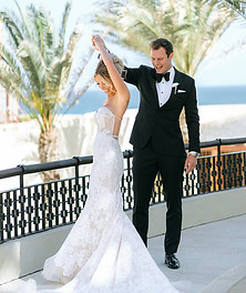 Bride and groom share a joyful dance at a luxury destination wedding in Cabo San Lucas.