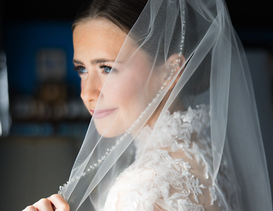 bride with soft natural wedding makeup and veil close-up