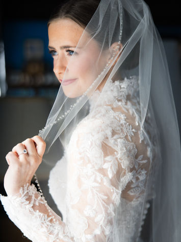 bride close up through veil with soft natural bridal makeup