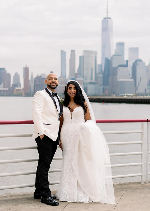bride and groom posing with city skyline view after wedding ceremony