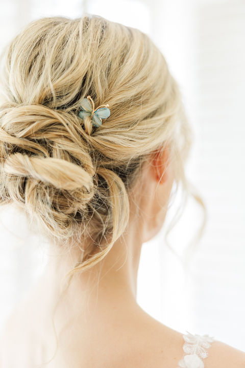 Blonde bride with romantic textured updo and delicate bridal hair pins