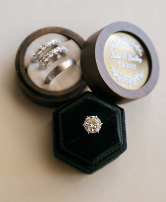Diamond engagement ring and wedding bands in elegant ring boxes at a destination wedding by Fabuluxe Events.