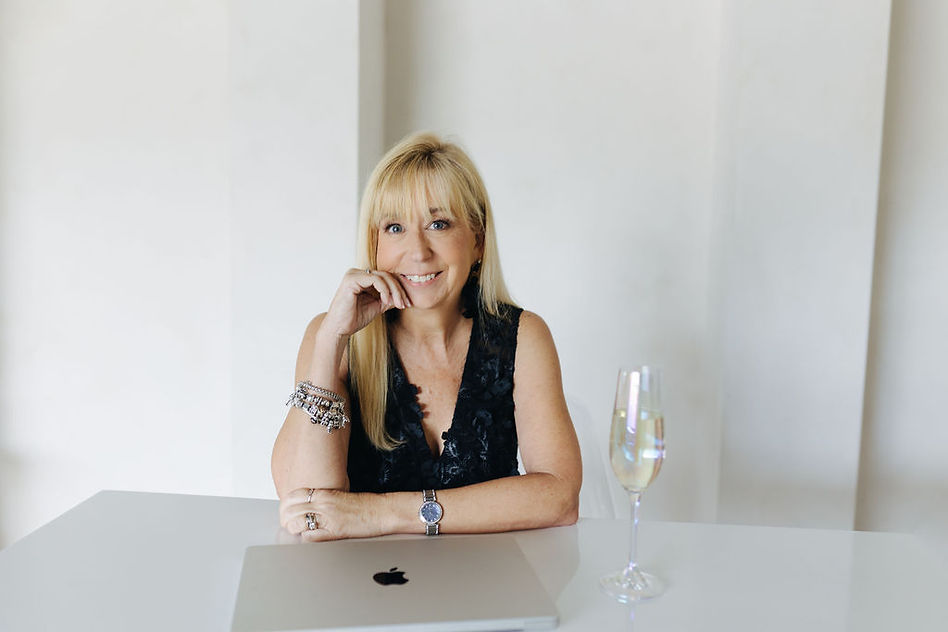 Jennifer Hardiman of Fabuluxe Events smiling confidently in her studio.