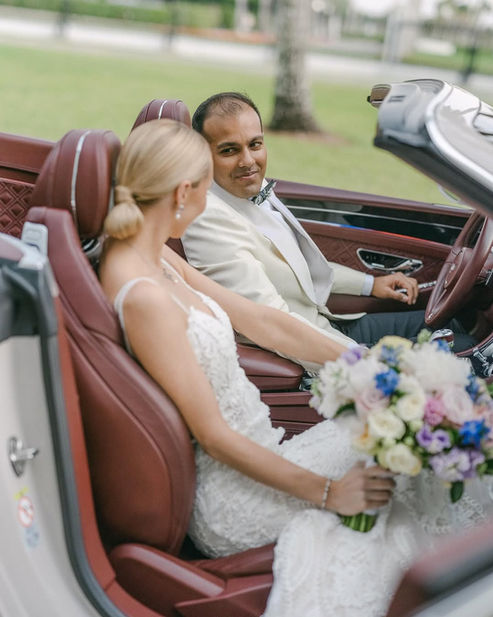 Bride and groom smiling in a convertible after their Boca Raton wedding ceremony