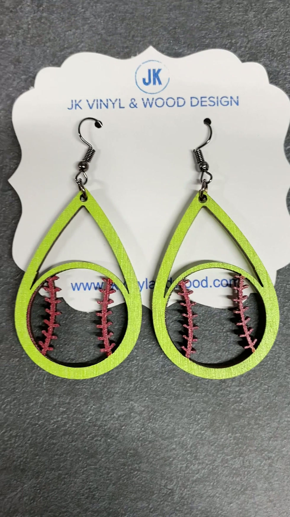 Thumbnail: Close up of laser cut baseball stitching detail on wooden teardrop earrings