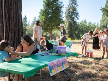Children playing at a festival on the north star house grounds assisted by volunteers