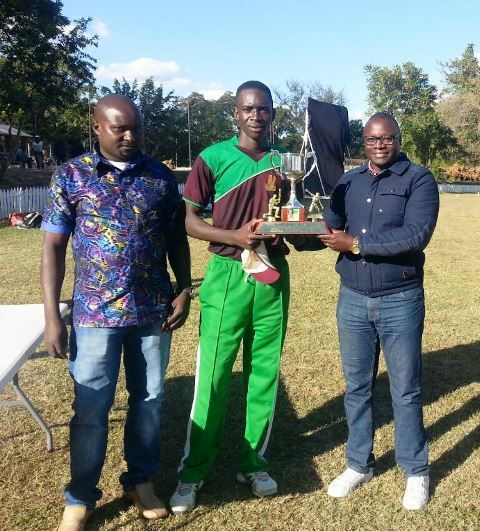 Blessed Muzite receiving the Associates Cup trophy