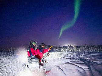 Evening snowmobile safari in the Arctic night — no sleigh, full speed, and a frozen swamp stop under the open sky.