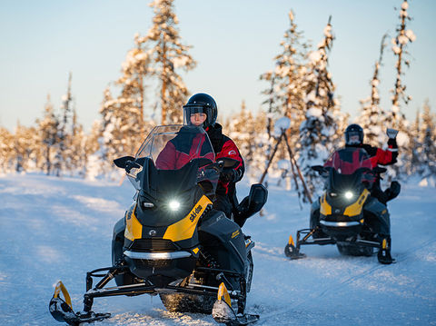 An afternoon snowmobile safari through private wilderness with a campfire kota hut lunch halfway through — grilled reindeer sausage, Finnish pancakes, adults only.