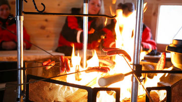 Traditional Lappish kota meal by the open fire