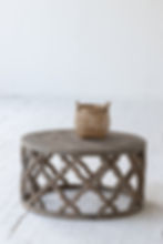 Rustic round coffee table made from recycled elm, showcasing a natural wood finish and detailed llofte-style carving