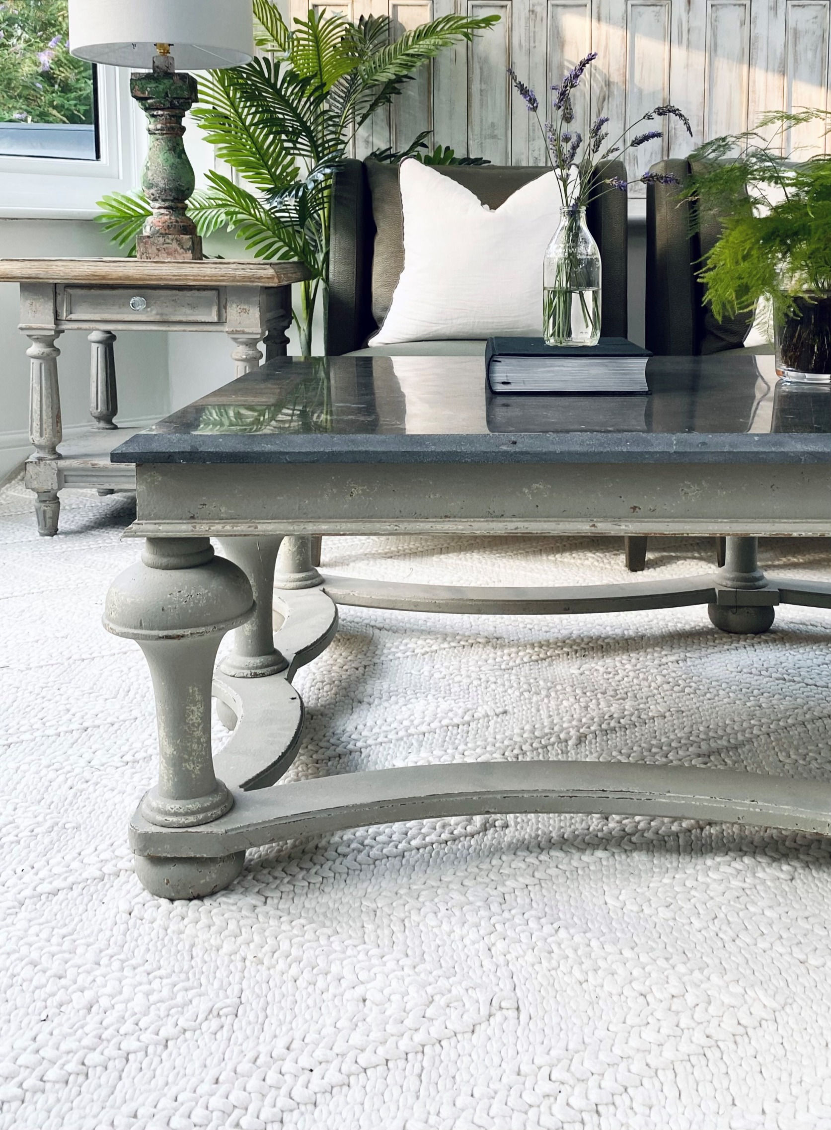 Woodcroft large grey balustrade coffee table with bold, sculptural base and a single slab blue stone top,