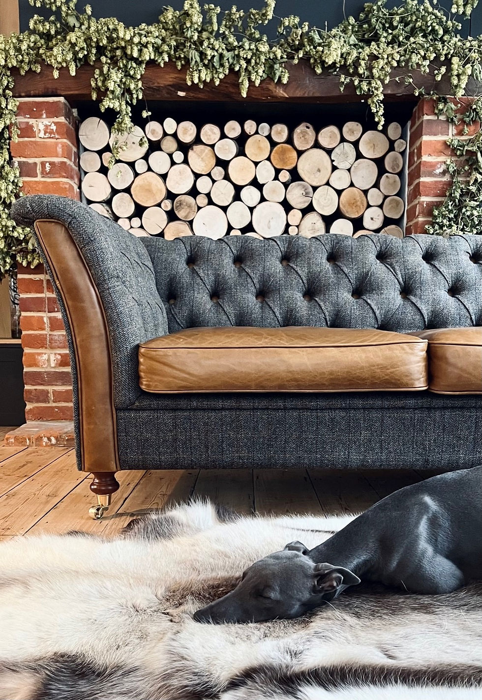 Compact countryside cottage-style sofa with slender arms, upholstered in Moreland Scottish Harris Tweed and soft leather