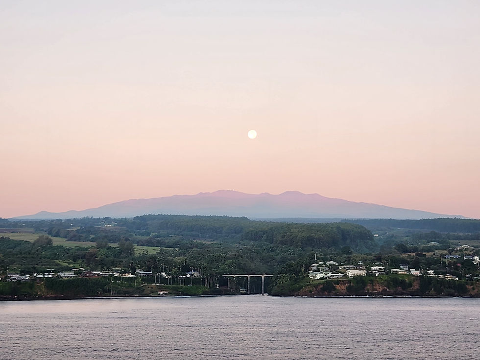 A scenic morning view of the coastline and mountains arriving in Hilo Hawaii during a cruise vacation, highlighting first time cruise shopping tips.