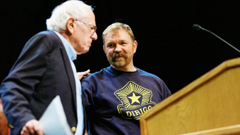 Graham Platner onstage campaigning with Bernie Sanders. 