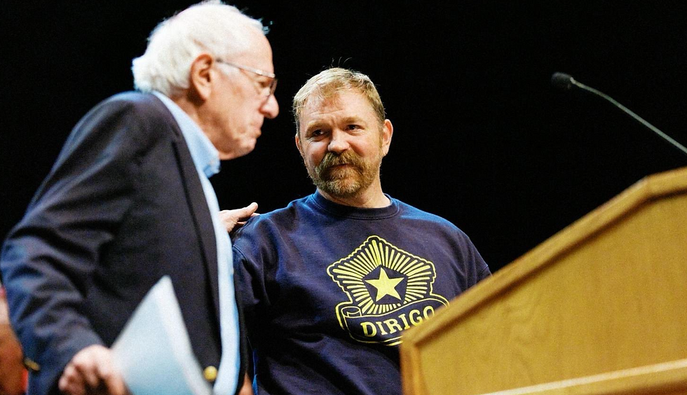 Graham Platner onstage campaigning with Bernie Sanders.