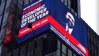 'Economic Developer of the Year' billboard seen in Times Square.