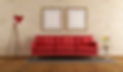 Red sofa in a living room with stone wal