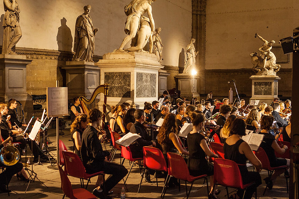 Young orchestra performing under the vaulted arches of the Loggia dei Lanzi, Piazza della Signoria, Florence