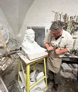 Sculptor working on marble sculpture in Florence artisan studio