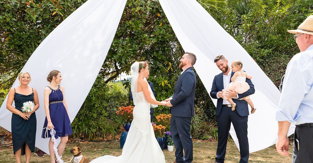 Couple exchanging vows at outdoor wedding ceremony