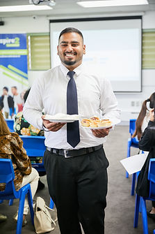 Smiling man serving refreshments at corporate event