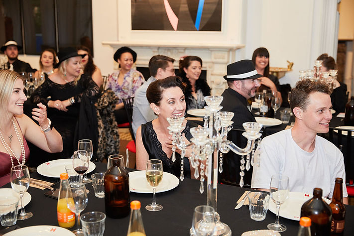Guests enjoying a 1920s themed dinner party
