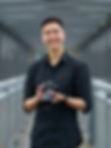 Smiling photographer holding camera, MayDream Photography