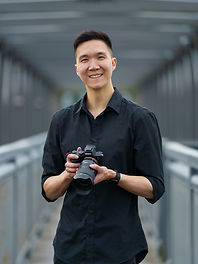 Smiling photographer holding camera, MayDream Photography