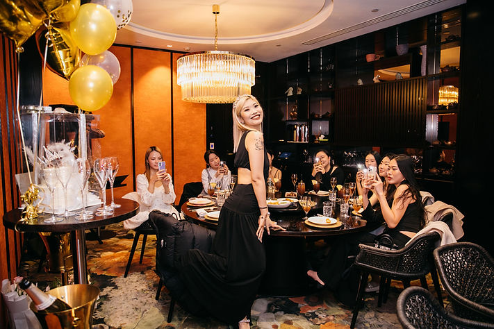 Woman celebrating birthday with friends at luxurious restaurant