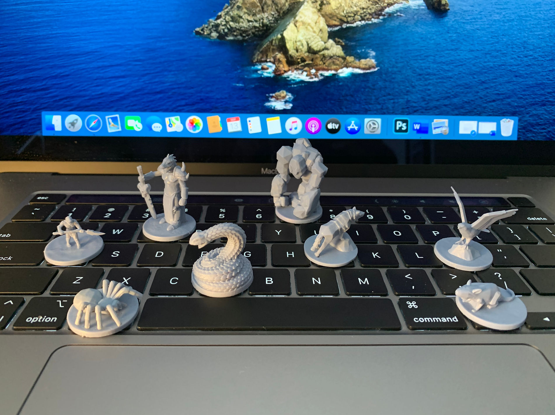 3D-printed tabletop game miniatures on laptop