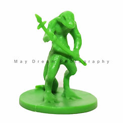 Green lizard-like figurine wielding a spear
