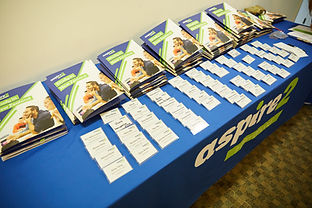 Guidebooks and name tags at a G-Spain event