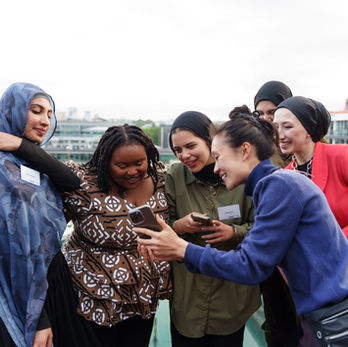 Smiling women looking at phone