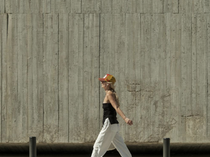 Woman walking on the pavement.