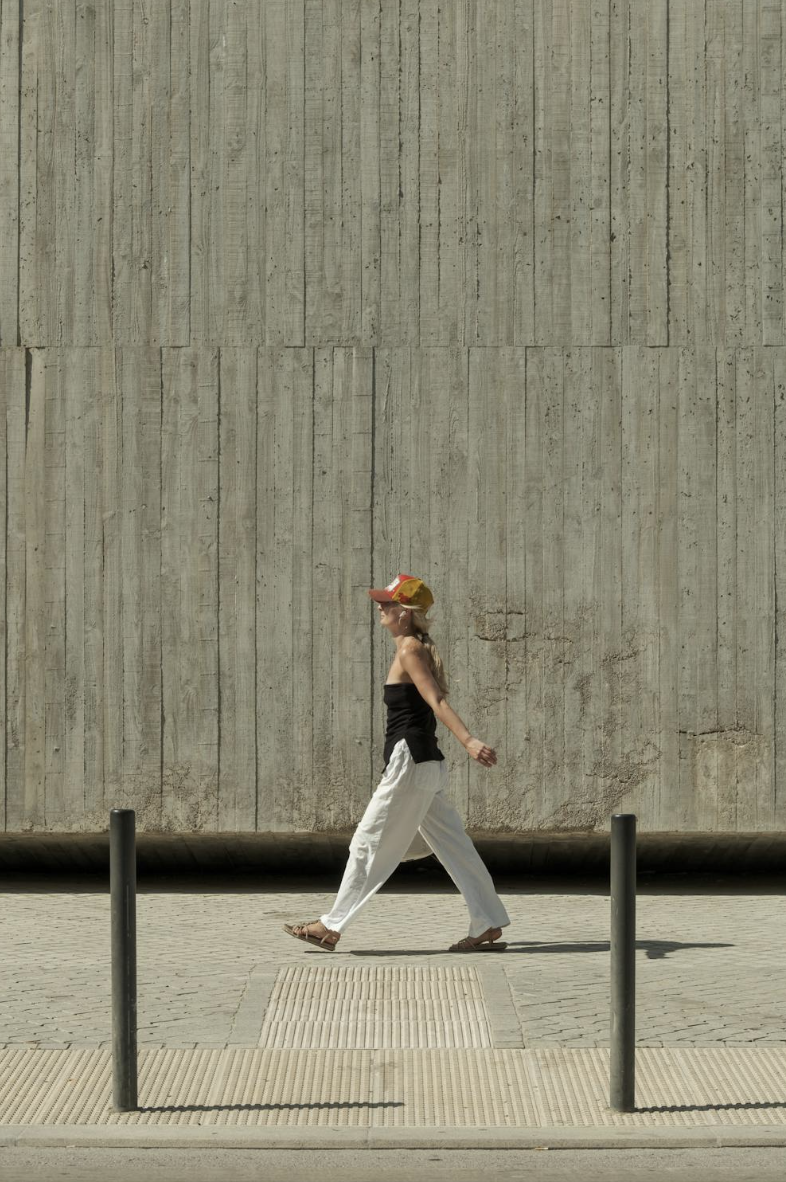 Woman walking on the pavement.