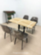 Real furniture picture: dining table and four plastic-wrapped chairs