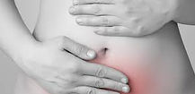 Woman holding abdomen in pain from endometriosis inflammation and severe menstrual cramps